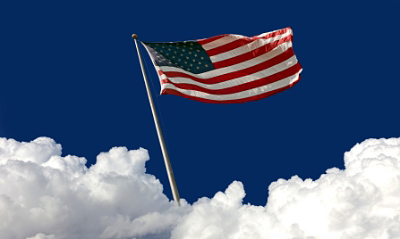 American Flag in the white clouds and blue sky